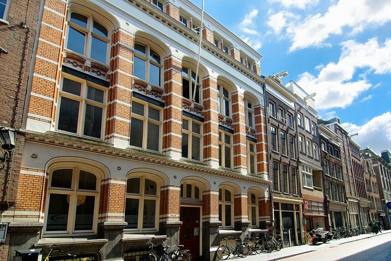 Exterior view of the historic brick and stone facade of Warmoesstraat 149-151.