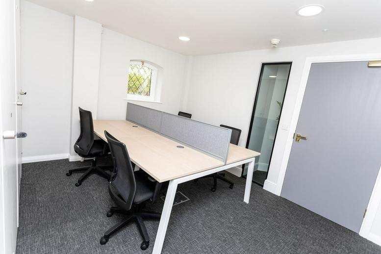 Spacious six-person office suite at Warrington South, Cheshire with natural light.