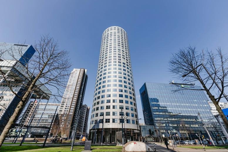 Exterior view of the iconic circular high-rise building at Weena 335, Rotterdam.