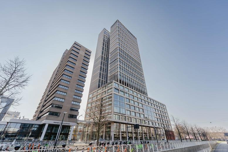 Exterior view of the modern glass and stone skyscraper at Weena 788, Rotterdam.