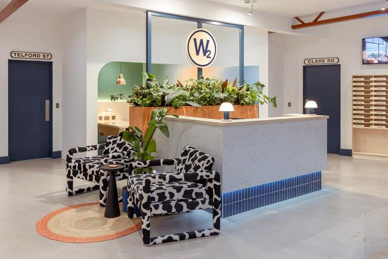 Bright reception area at Wellington House, Wellington Street, Cardiff featuring cow-print chairs and a wood-topped desk.