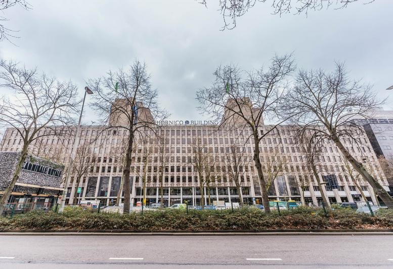 Exterior view of the multi-story stone facade building at Westblaak 92, Rotterdam.