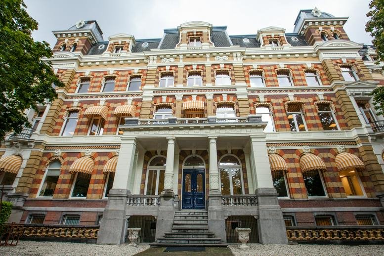 Grand historic facade of Westplein 12, Rotterdam, South Holland with brickwork and classic architectural details.