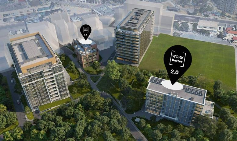 Aerial view of the building complex showing three modern structures and green spaces.