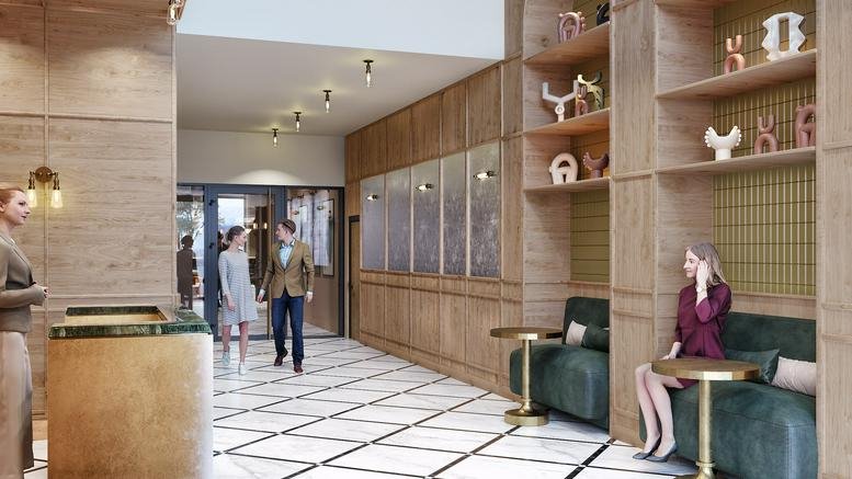 Grand wood-paneled lobby with a golden reception desk at Zimmerstrasse 78, Berlin.