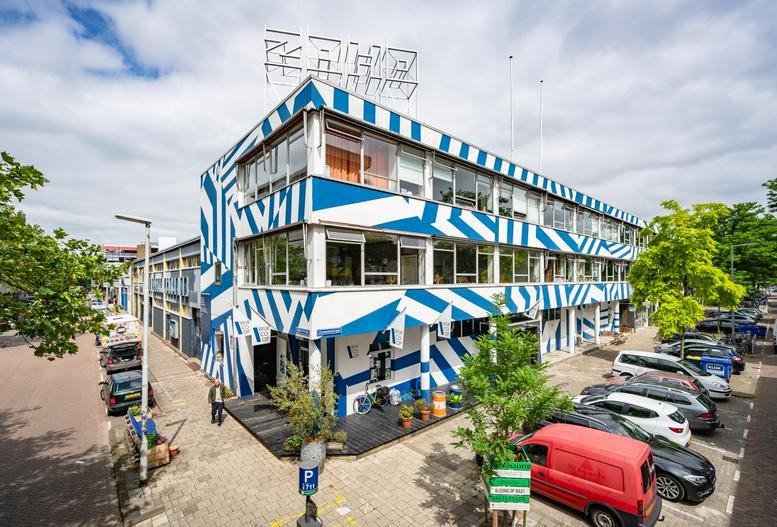 Exterior view of the blue and white striped facade of the Zomerhofstraat 71 building.