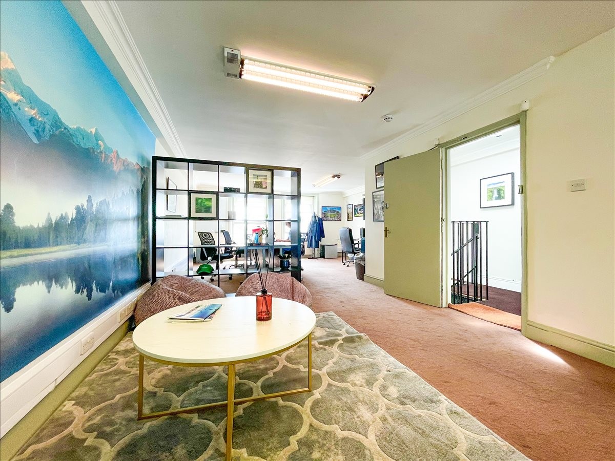 Spacious breakout area at 208 Fulham Road, 3rd Floor with a large mountain mural and lounge seating.