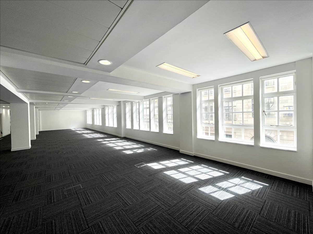 Spacious, well-lit open-plan office at 27 Old Jewry with dark grey carpet tiles and large windows.