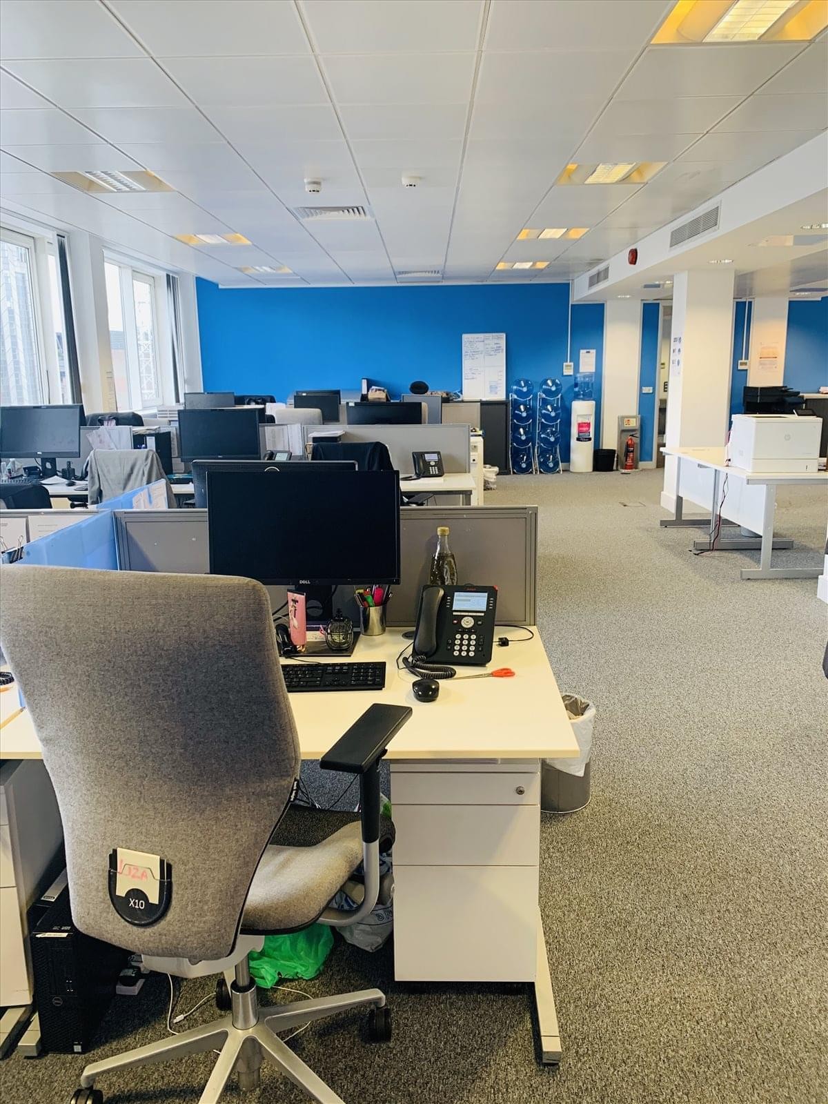 Spacious open-plan office at St Clare House, 30-33 Minories, showing multiple desks and blue partitions.