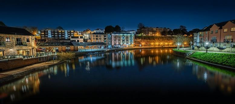 Exterior view of The Gallery, Kings Wharf, The Quay overlooking the river at dusk.
