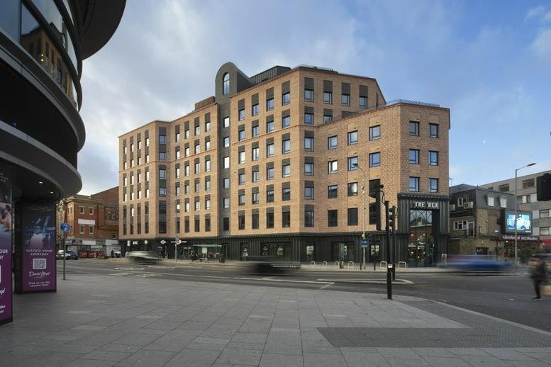 Exterior view of the brick facade at The Rex, 175 Clarence Street, showing street-level retail and windows.