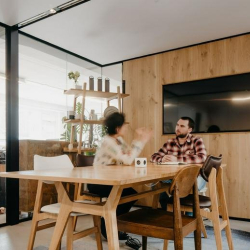 Private wood-paneled meeting room with a flat-screen TV and wooden conference table.