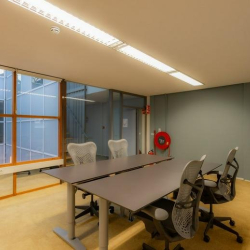 Meeting room with a long table and mesh office chairs.