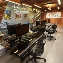 Sleek workspace with long black desks and ergonomic seating.