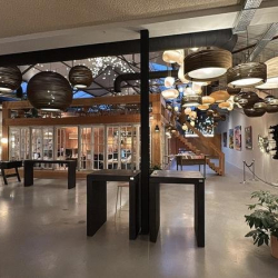 Large open-plan common area with a variety of decorative hanging lamps.