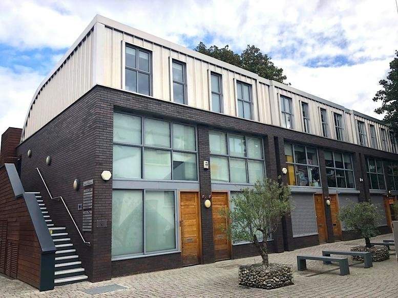 Exterior facade of Units 4 & 10, Turnham Green Terrace Mews with dark brick and large windows.