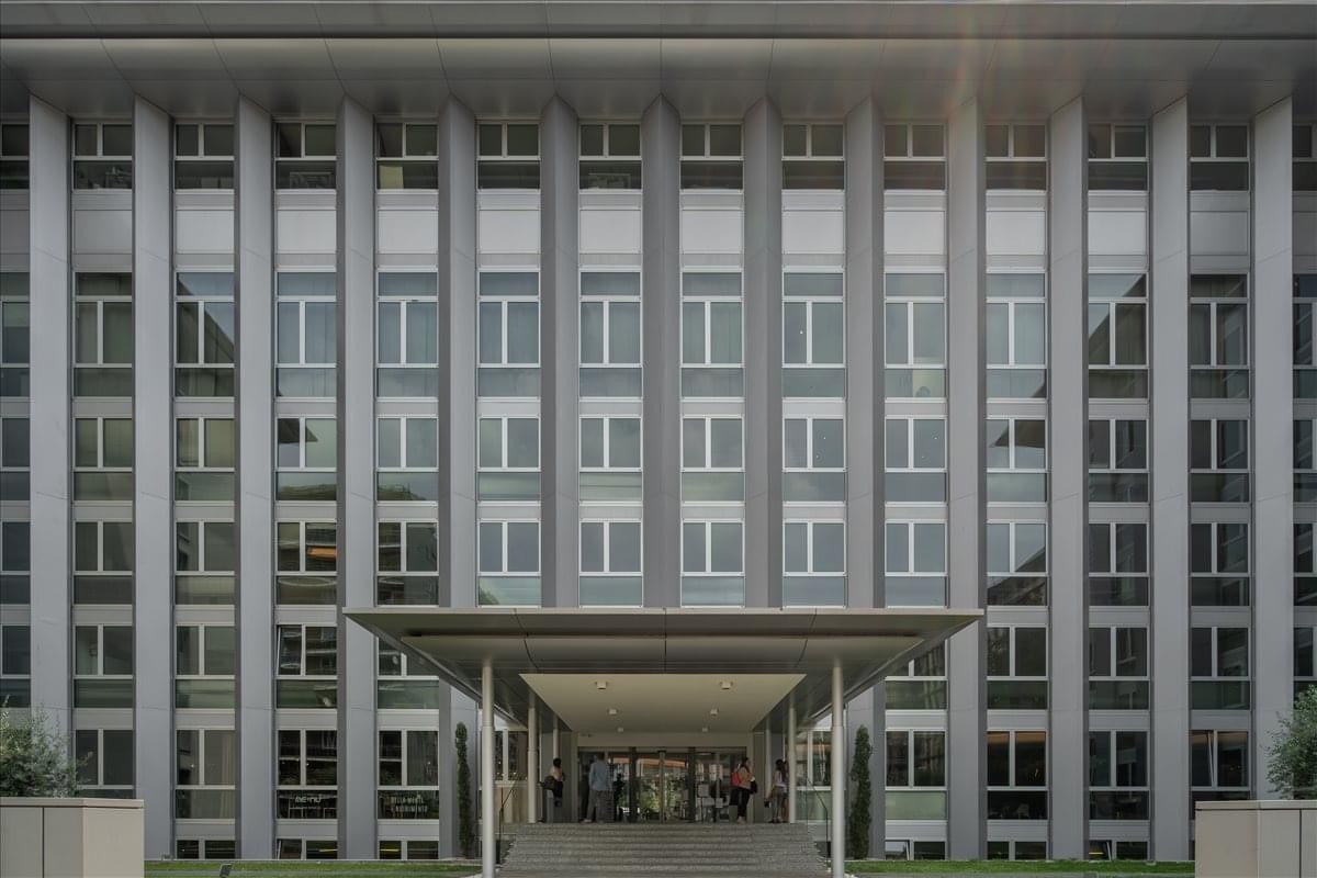 Exterior view of the multi-story office building at Via Copernico, 38, Milan, Italy with a grid-like facade.
