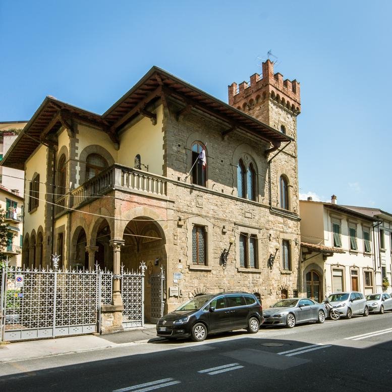 Exterior view of the historic stone building facade of Via Guglielmo Marconi.