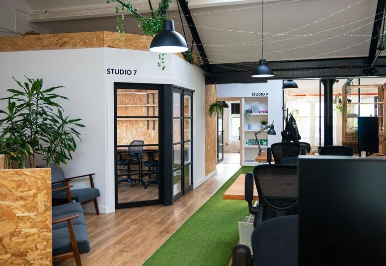 Spacious communal area at Western House, Western Street, featuring indoor plants and a green artificial grass walkway.