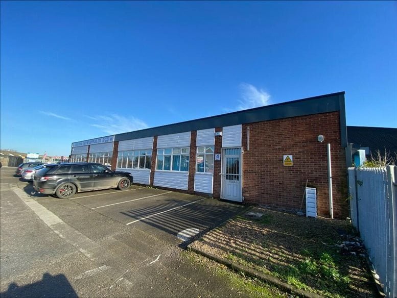 Exterior view of the brick and white-paneled facade of Unit 1, Aqua Park, Hull under a clear blue sky.