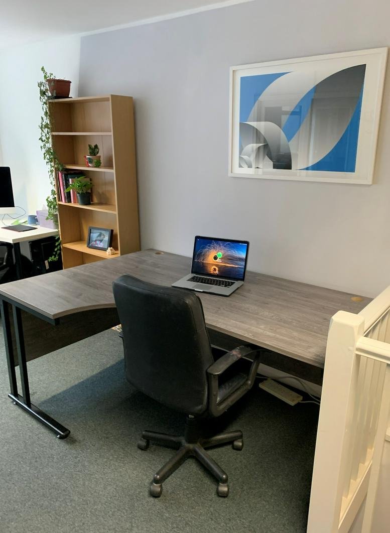 Large wooden L-shaped desk with a laptop and office chair at 8 Bond Street, Brighton, East Sussex.