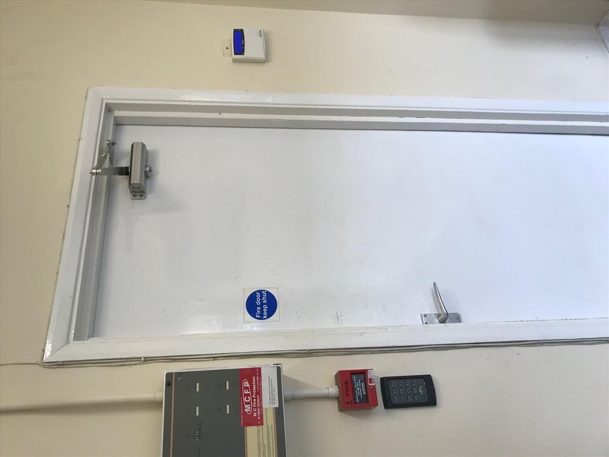 Exterior view of the white-fronted office building at Bicester, Oxfordshire with symmetrical windows.