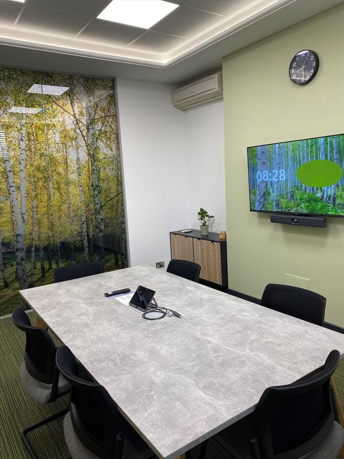 Meeting room at Chapel Lane, Totton, Southampton featuring a marble-style table and a nature-themed accent wall.
