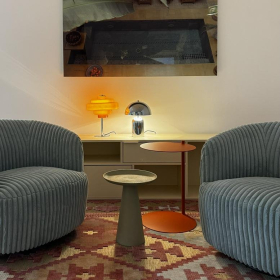 Waiting area with blue corduroy armchairs and a patterned rug at 10, Cecilienallee, Cecilienpalais.. Click for details.