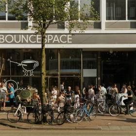 Exterior view of the Bouncespace building at 141, Overtoom with people and bikes outside.. Click for details.